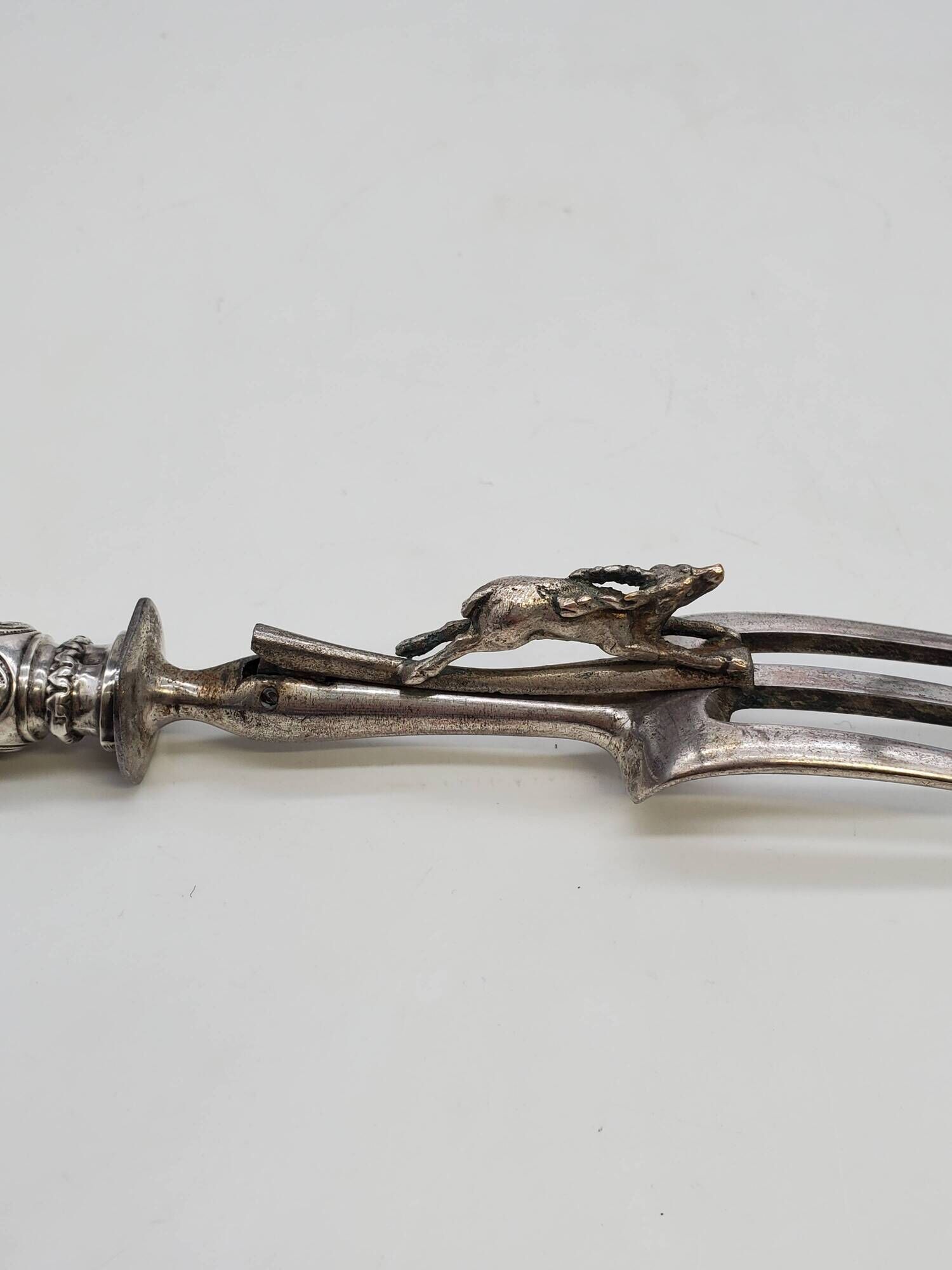 Set of serving forks and silver-plated leg of lamb fork.