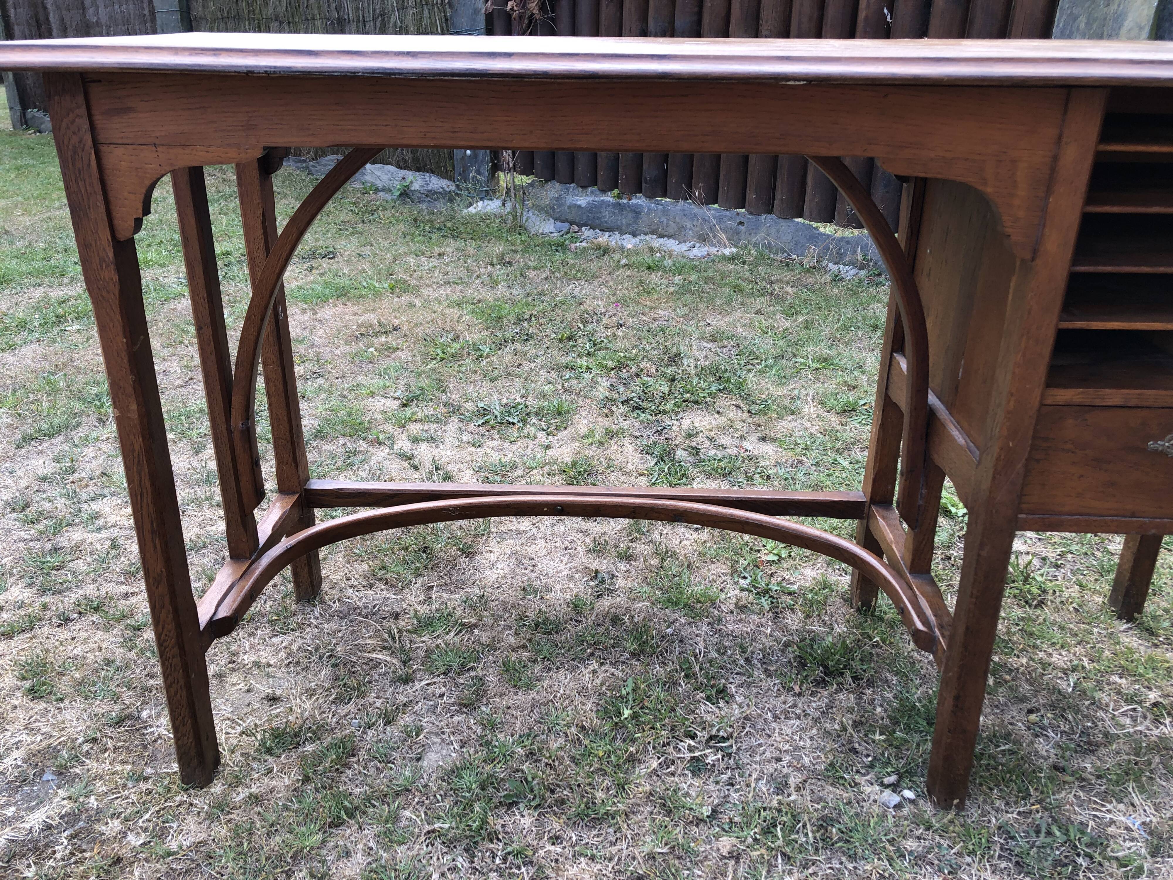 Old oak desk with curved wooden sleepers in the Art Nouveau spirit of the early 20th century.