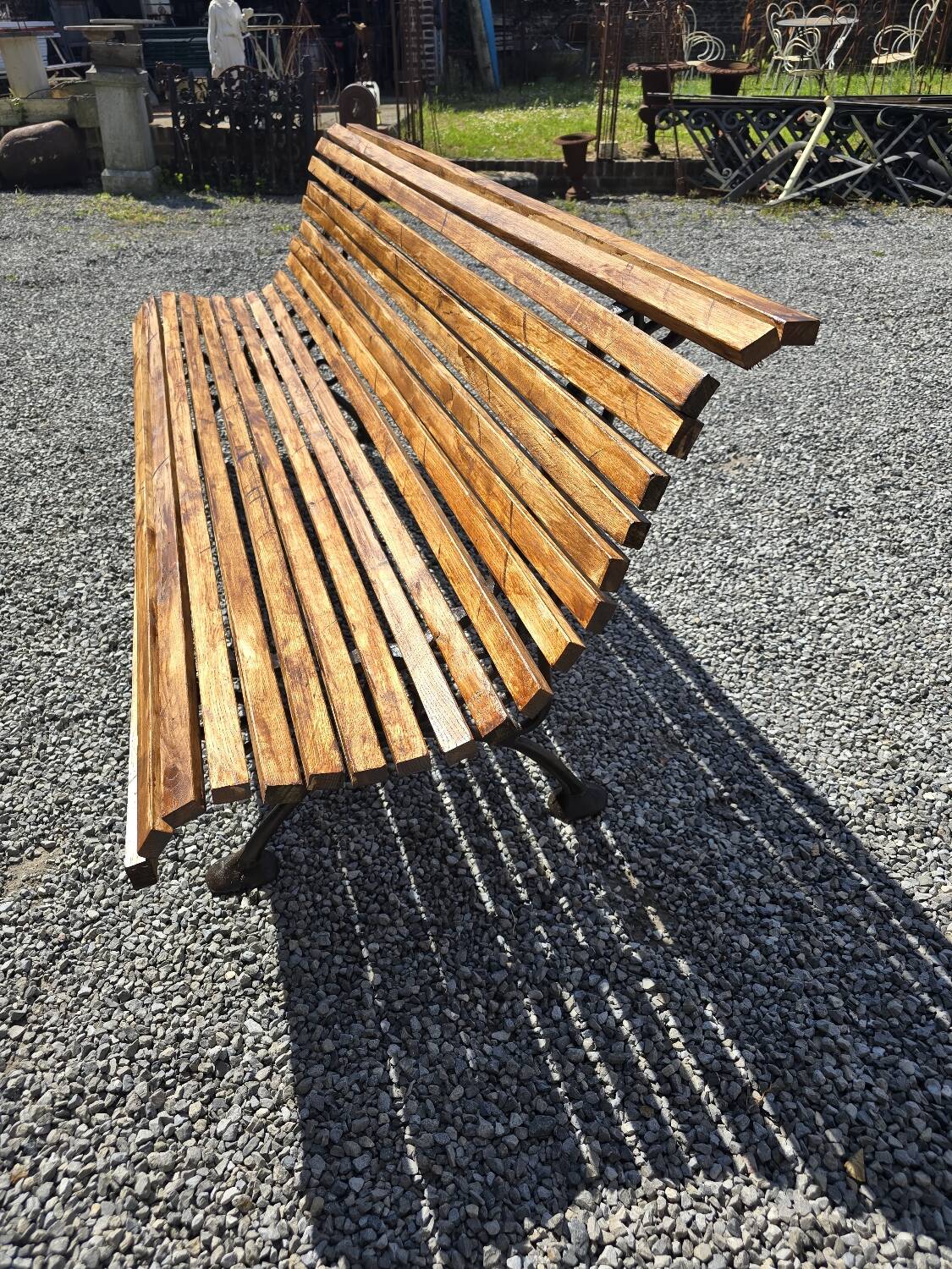 Wooden garden bench with cast iron base