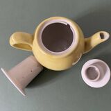 Small lemon yellow porcelain teapot with filter