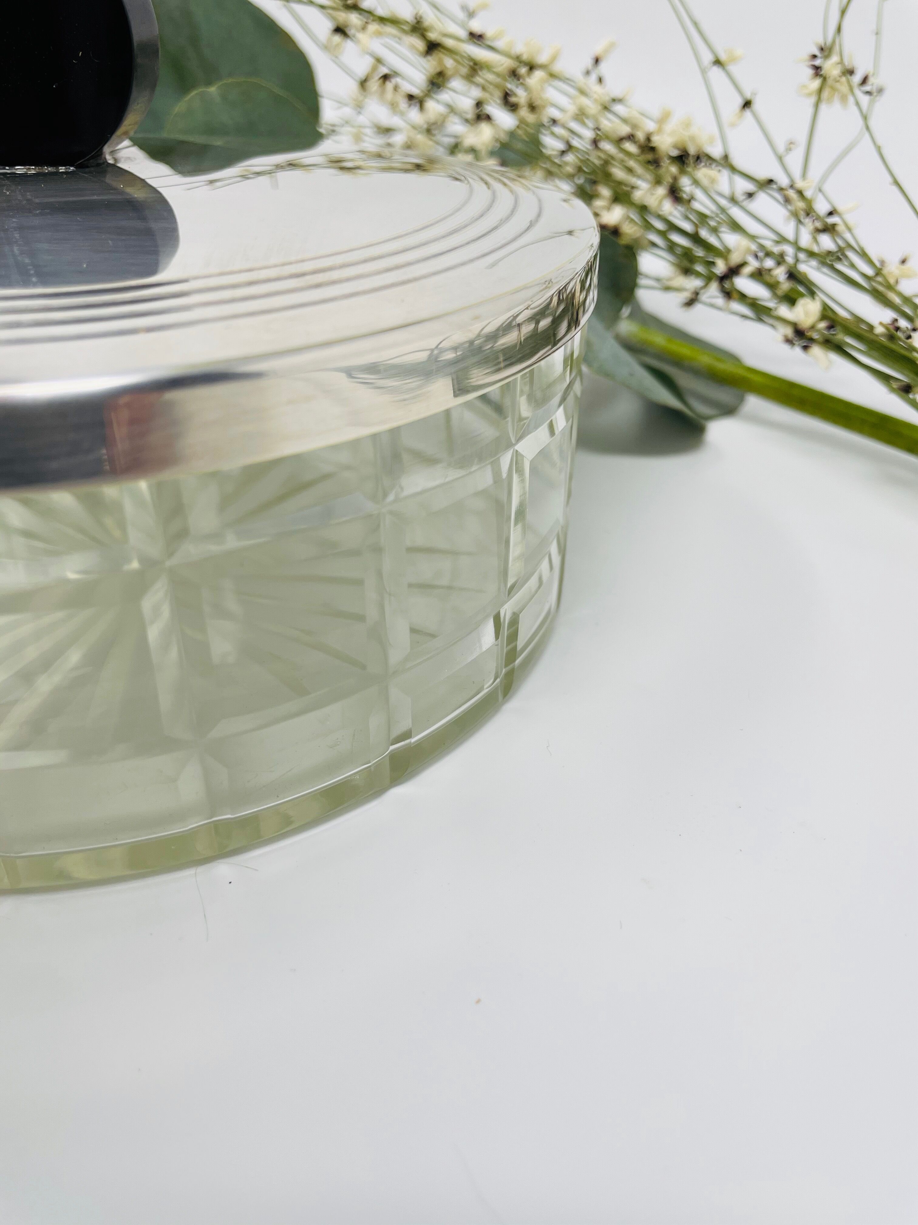 Vintage box made of chiseled glass and covered metal, taken in black Bakelite