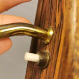 Wall light in rosewood with bobble glass ball shade.
