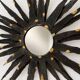 Large brutalist sun mirror in patinated metal with gold accents, 1970.