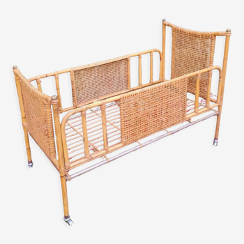 Rattan crib on vintage wheels