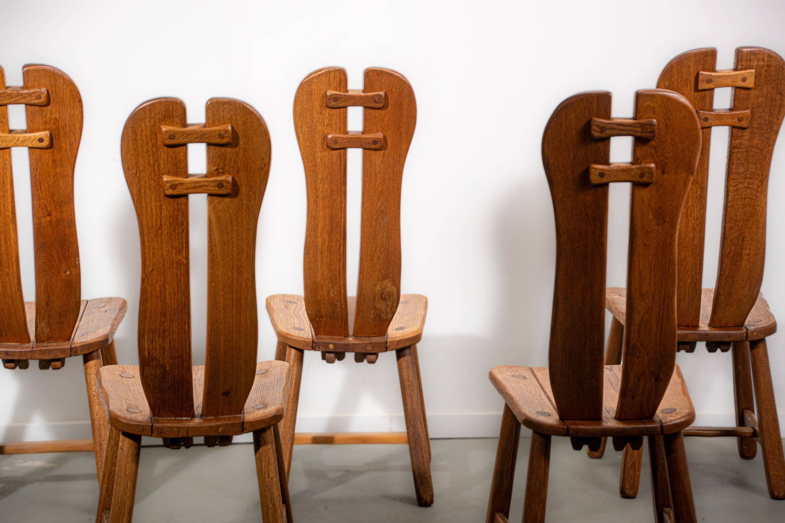 De Puydt brutalist dining chairs in solid oak. Circa 1970.