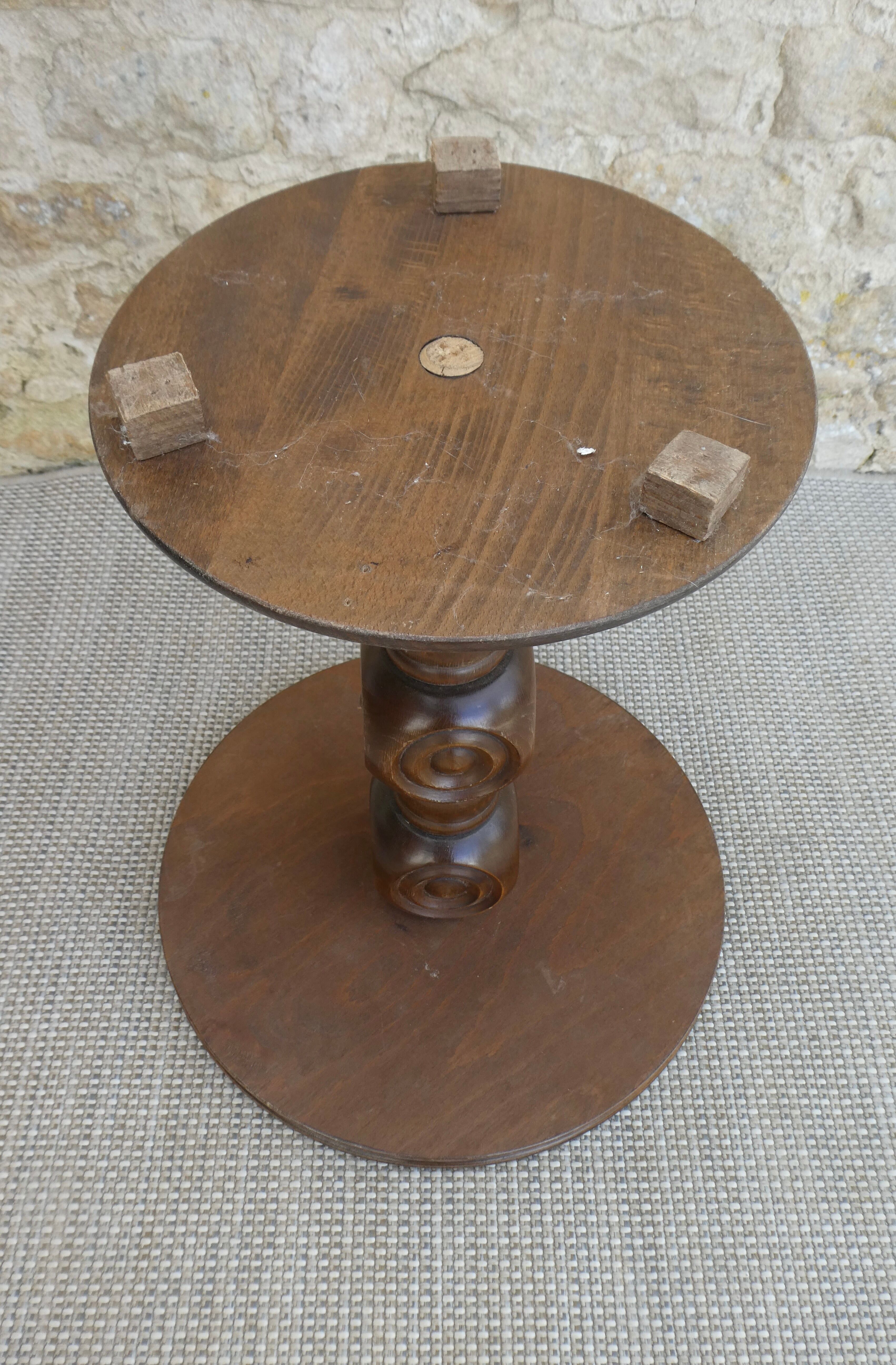 Pedestal table on carved wooden base