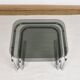 Pair of nesting tables in smoked glass and chrome legs.