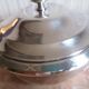 silver metal vegetable dish with crossed ribbon decoration