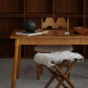 Folding stool, reupholstered in long-haired sheepskin, mid-century modern style, 1950s.