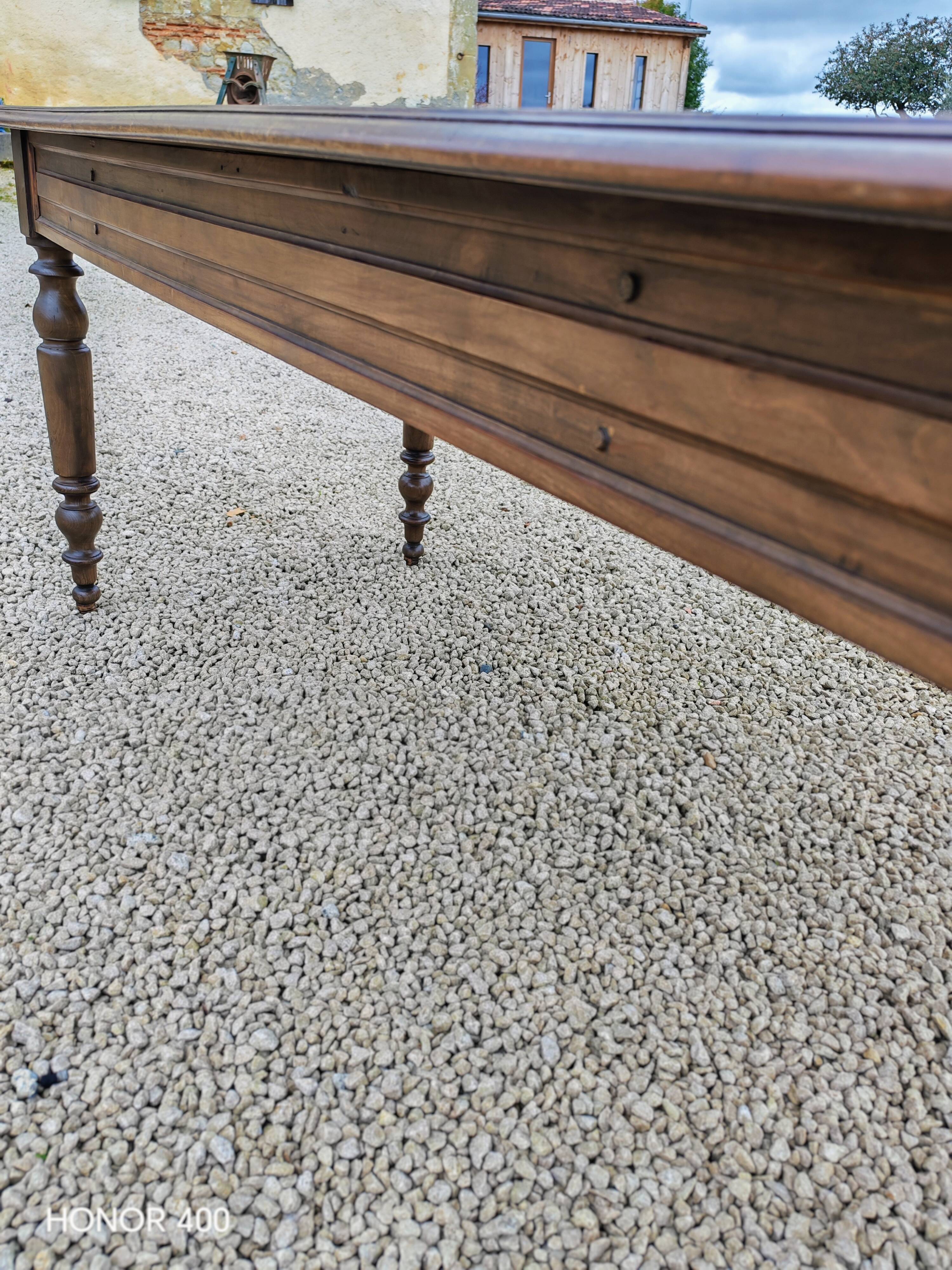 Old French farmhouse table in walnut with turned legs.