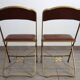 2 golden metal chairs with faux leather in the 60s/70s Opera style.