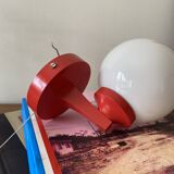 Red plastic wall light with a white opaline glass globe.
