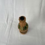 Green bottle with wicker decoration