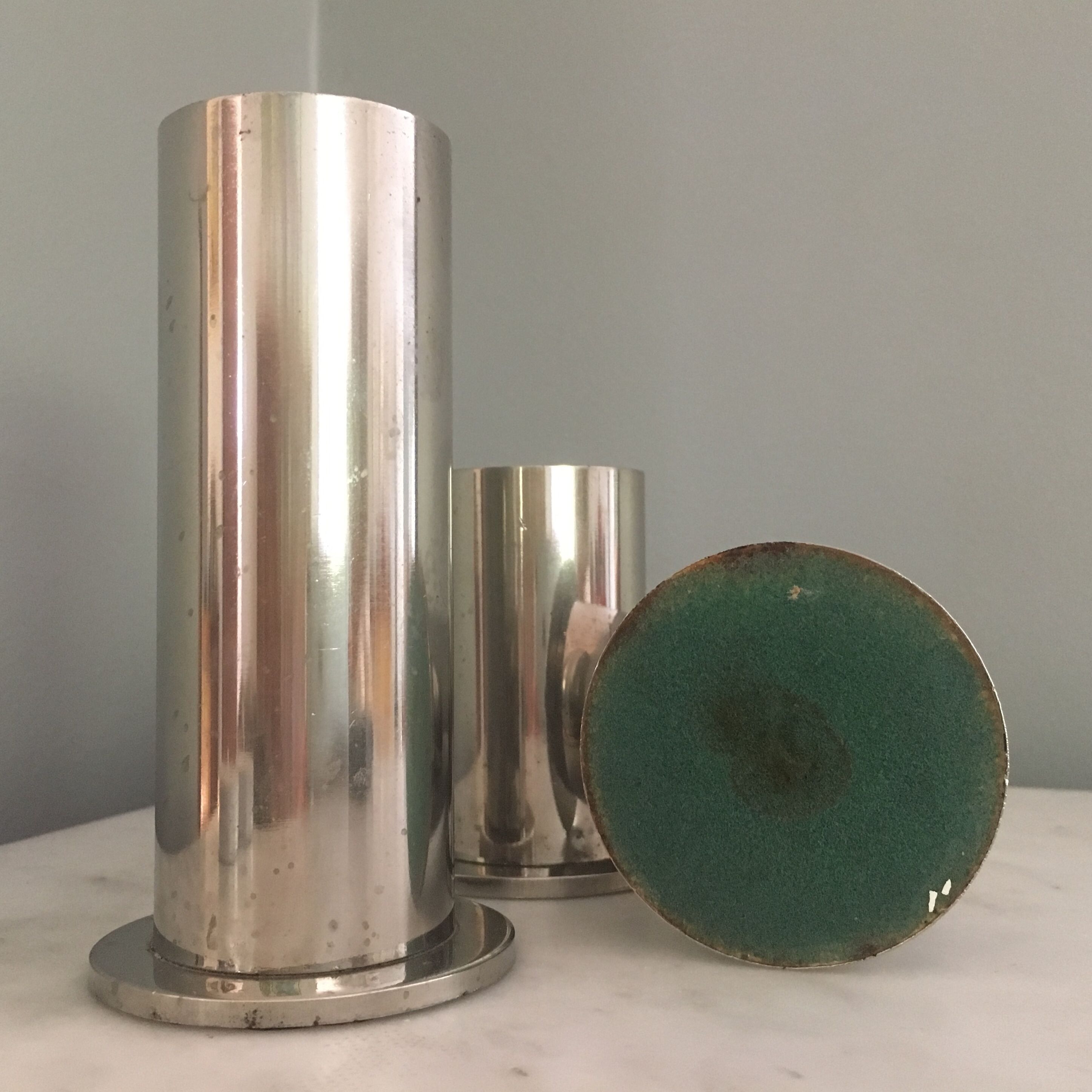 Suite of three brushed steel candlesticks from the 1970s