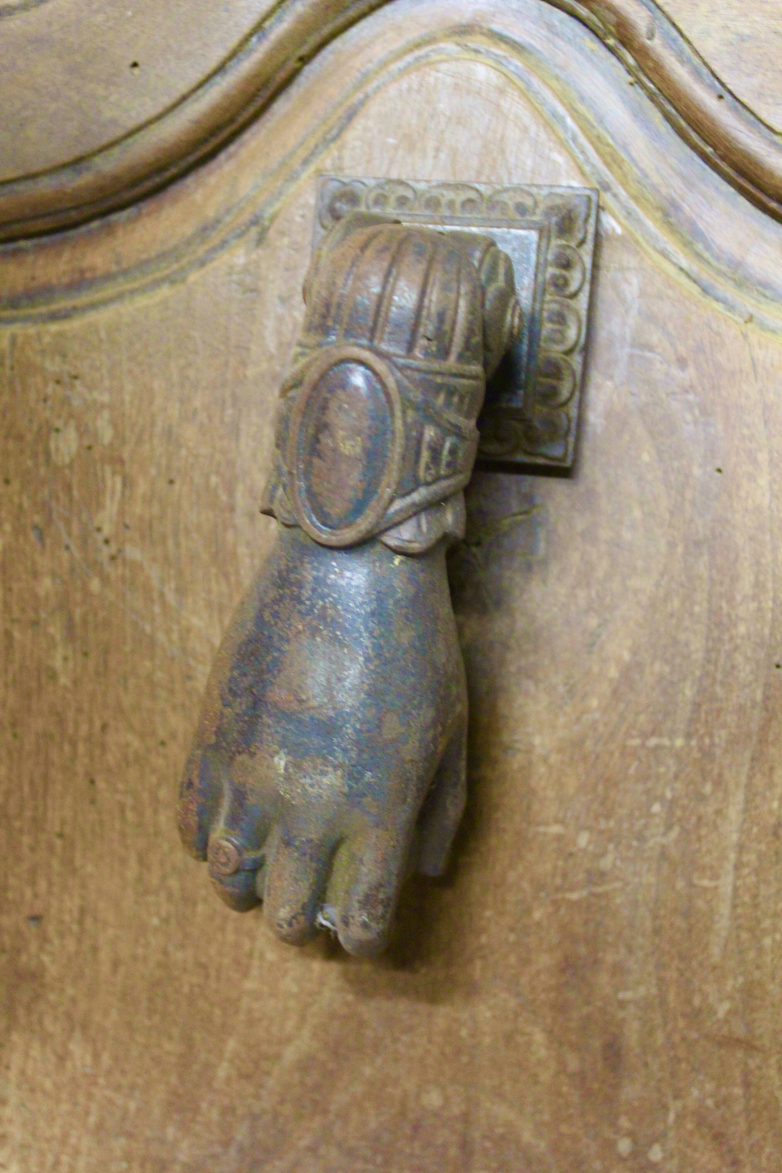 Antique cast iron door knocker in the shape of a 19th century hand