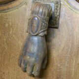 Antique cast iron door knocker in the shape of a 19th century hand