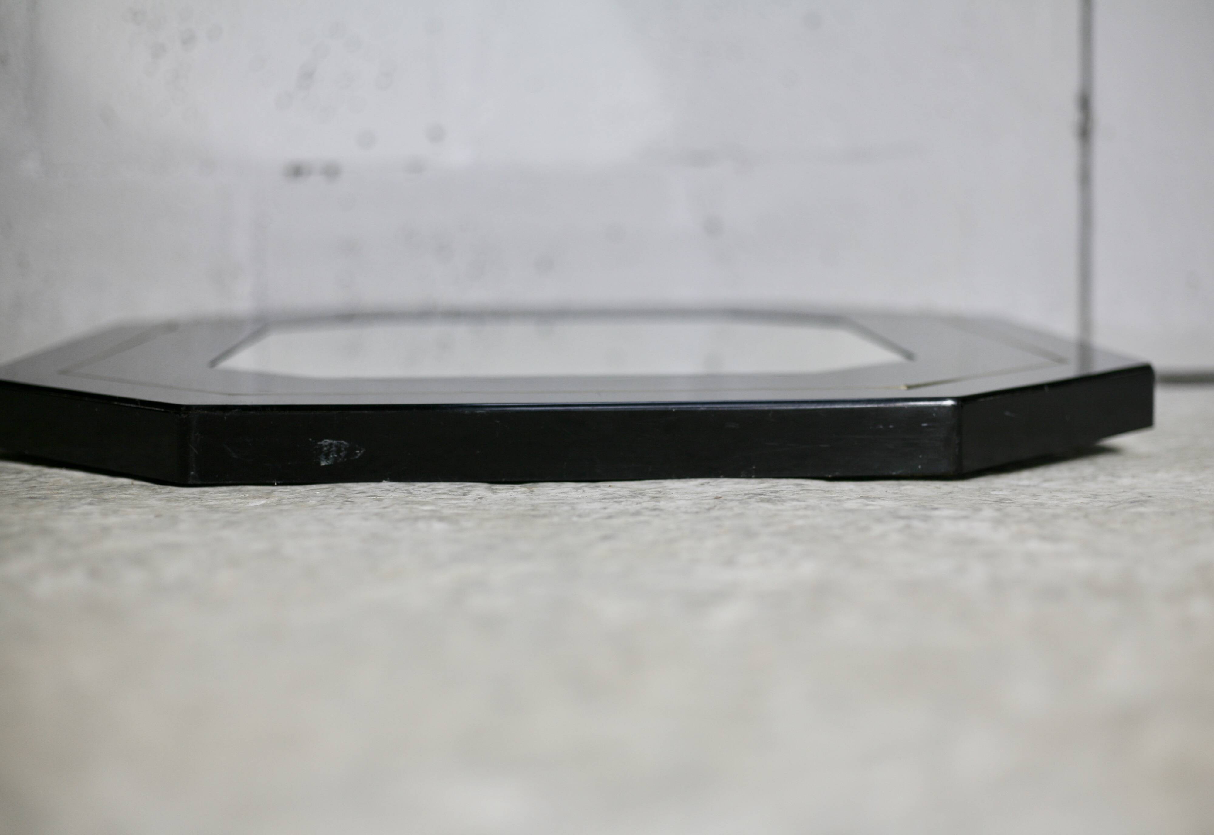 70s mirror, black lacquered wood, brass edging. Octagonal