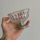 Thick glass bowl on a metal stand.