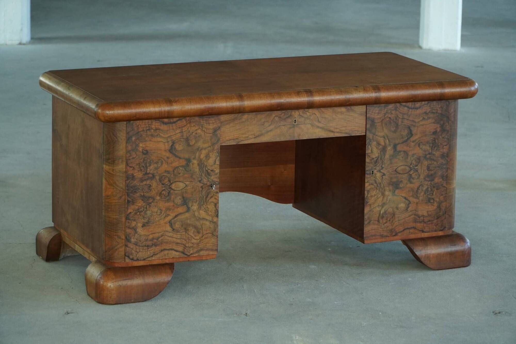 Art Deco desk, sculptural and expressive, in walnut, made by a French cabinetmaker, 1930s.