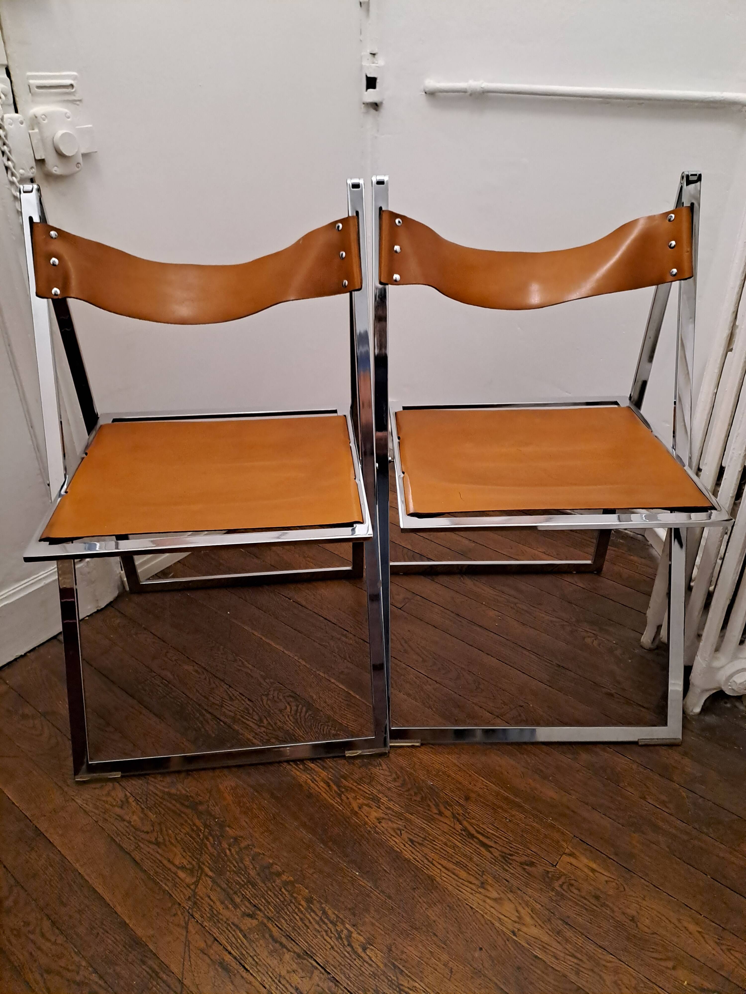 2 Chromed metal and leather folding chairs. 70s. Fontoni & Geraci