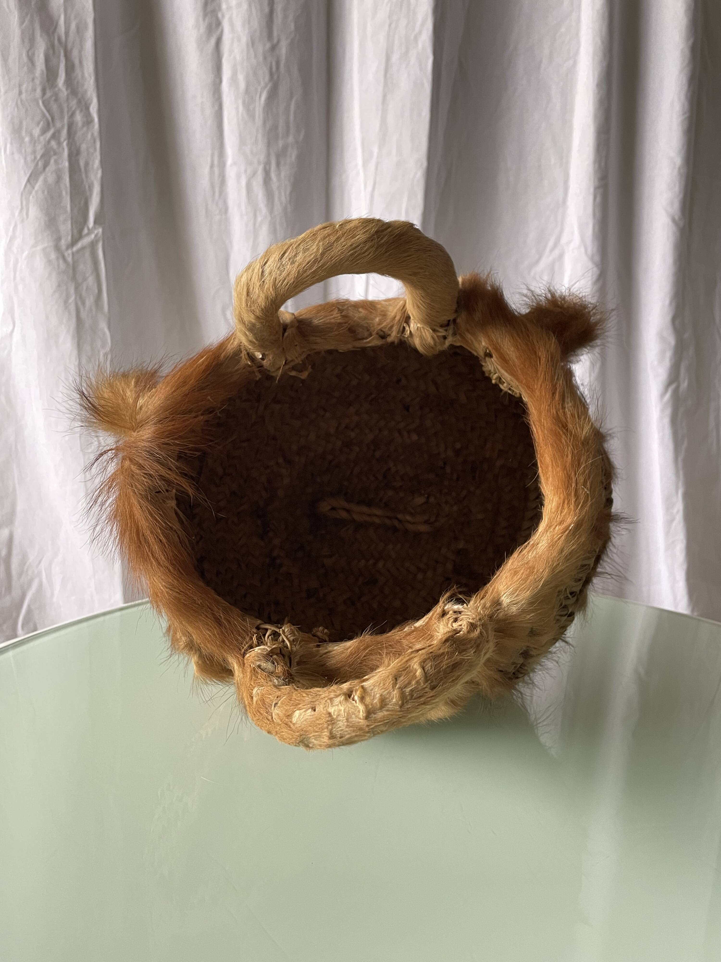 Handwoven vintage basket with handles made from natural fibres.