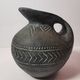 Vintage native american jug pot with geometric patterns in green / gray tones