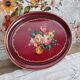 Russian plate in painted sheet metal burgundy old pink decoration and golden frieze