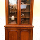 English showcase in two mahogany bodies and 19th century veneer