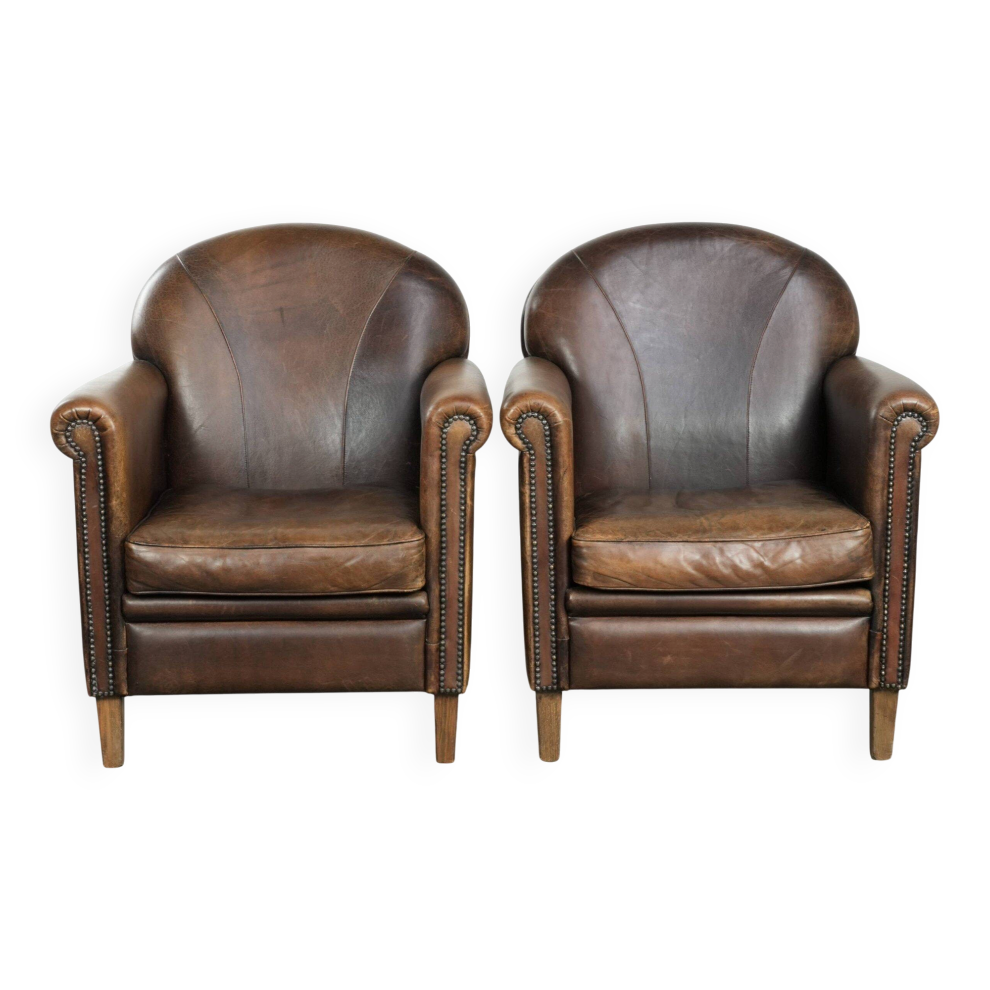 Characterful set of two sheepskin design armchairs with beautiful patina