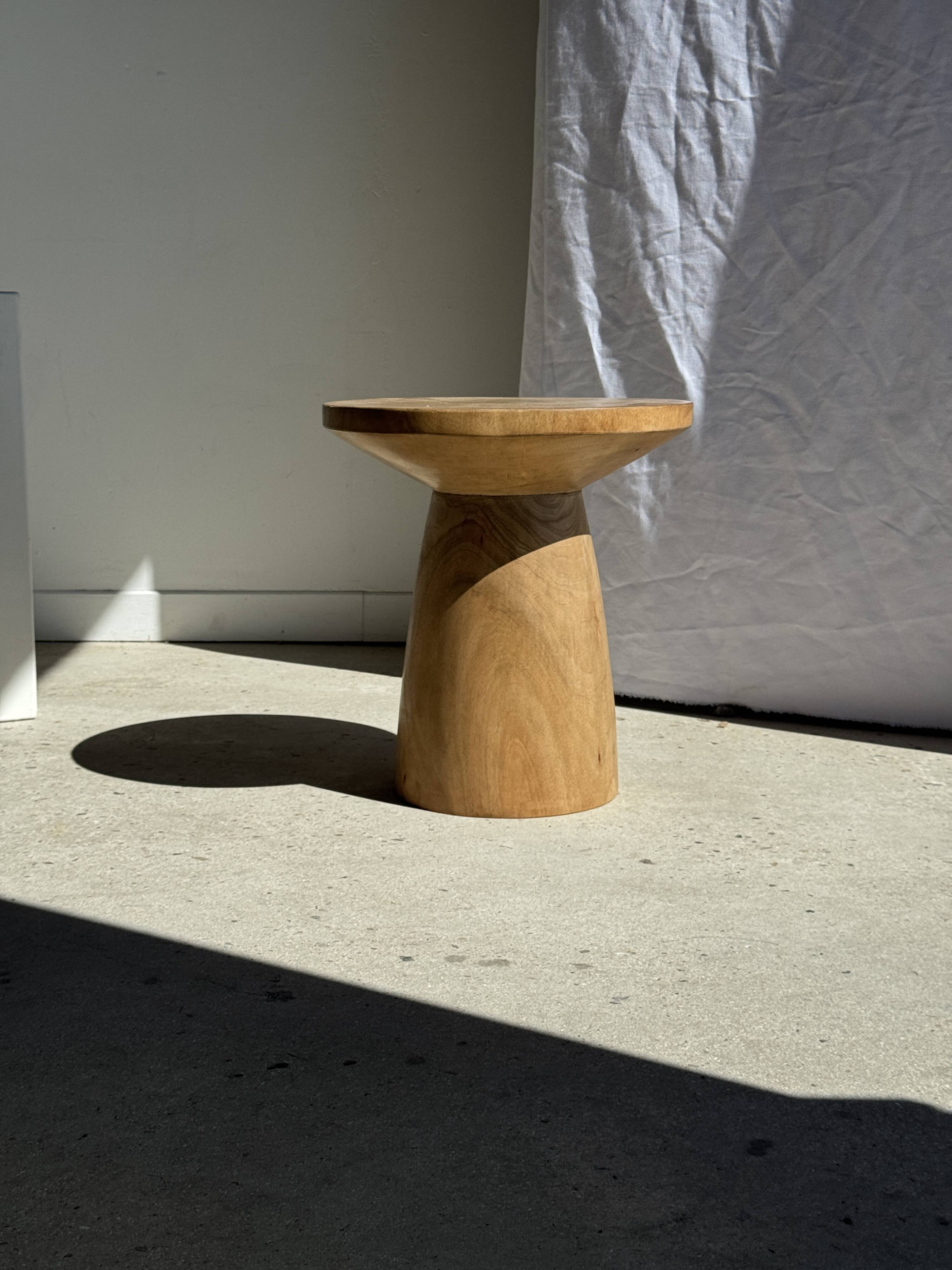 Natural solid mango side table (monoxyle) with conical legs.
