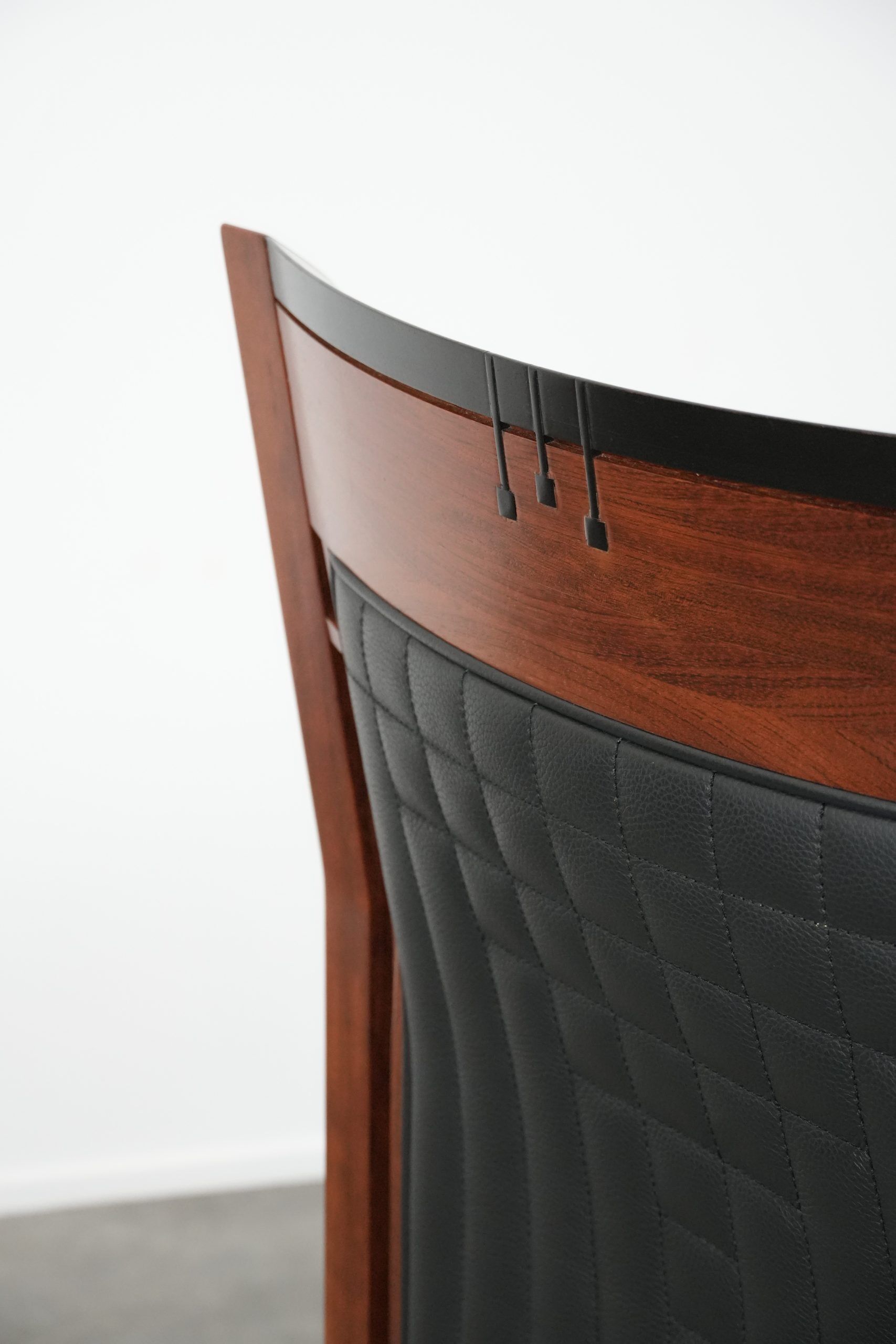 Art Deco design armchair with black leather with decorative stitching