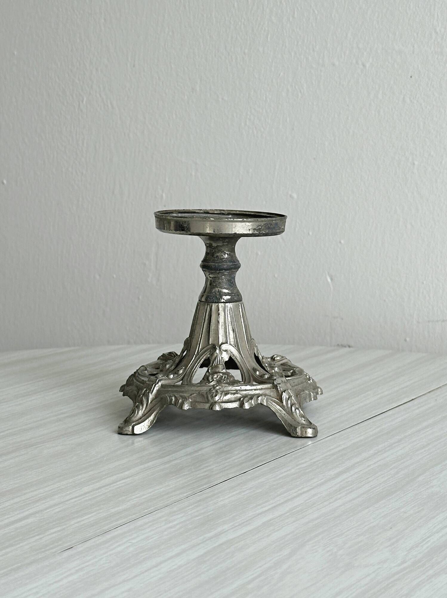 Candle holder with sculpted metal base, antique.