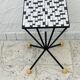Wrought iron stela and black and white tiled top from the 1960s.