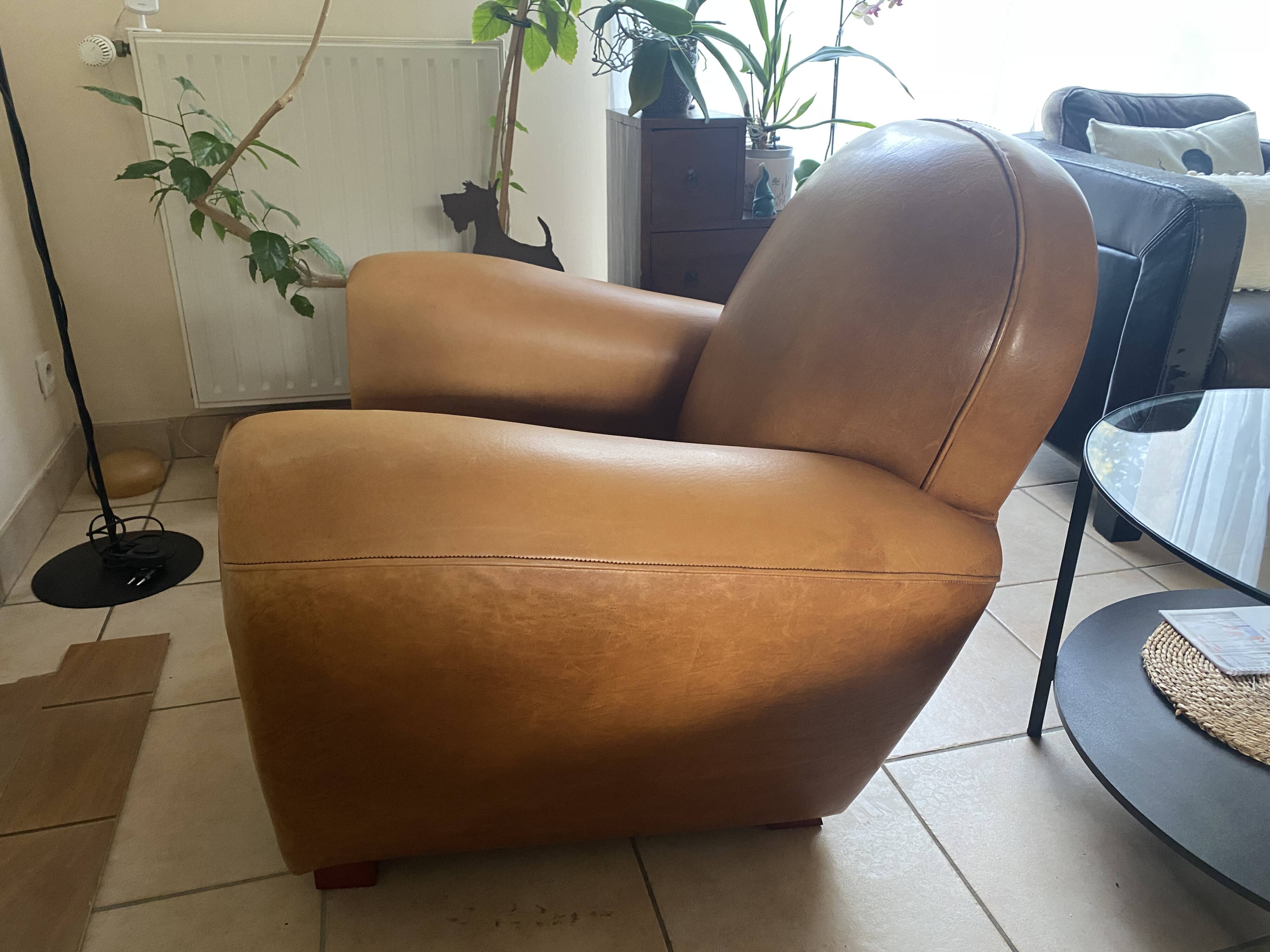 Brown leather club armchairs with an antique finish.