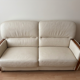 Beige leather sofa with solid wood frame