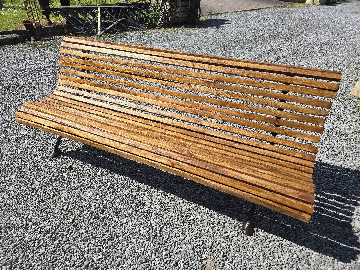 Wooden garden bench with cast iron base