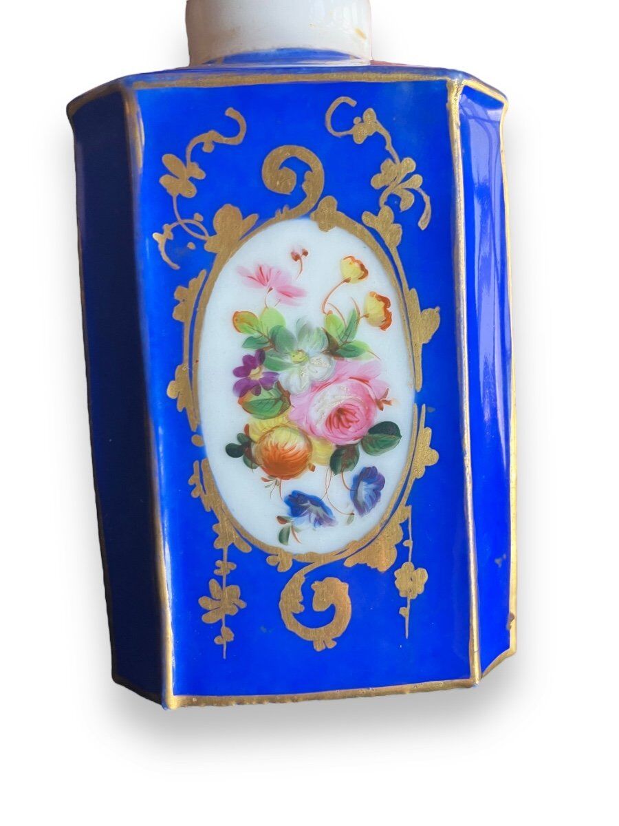 Perfume bottle in porcelain of old paris blue background