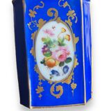 Perfume bottle in porcelain of old paris blue background