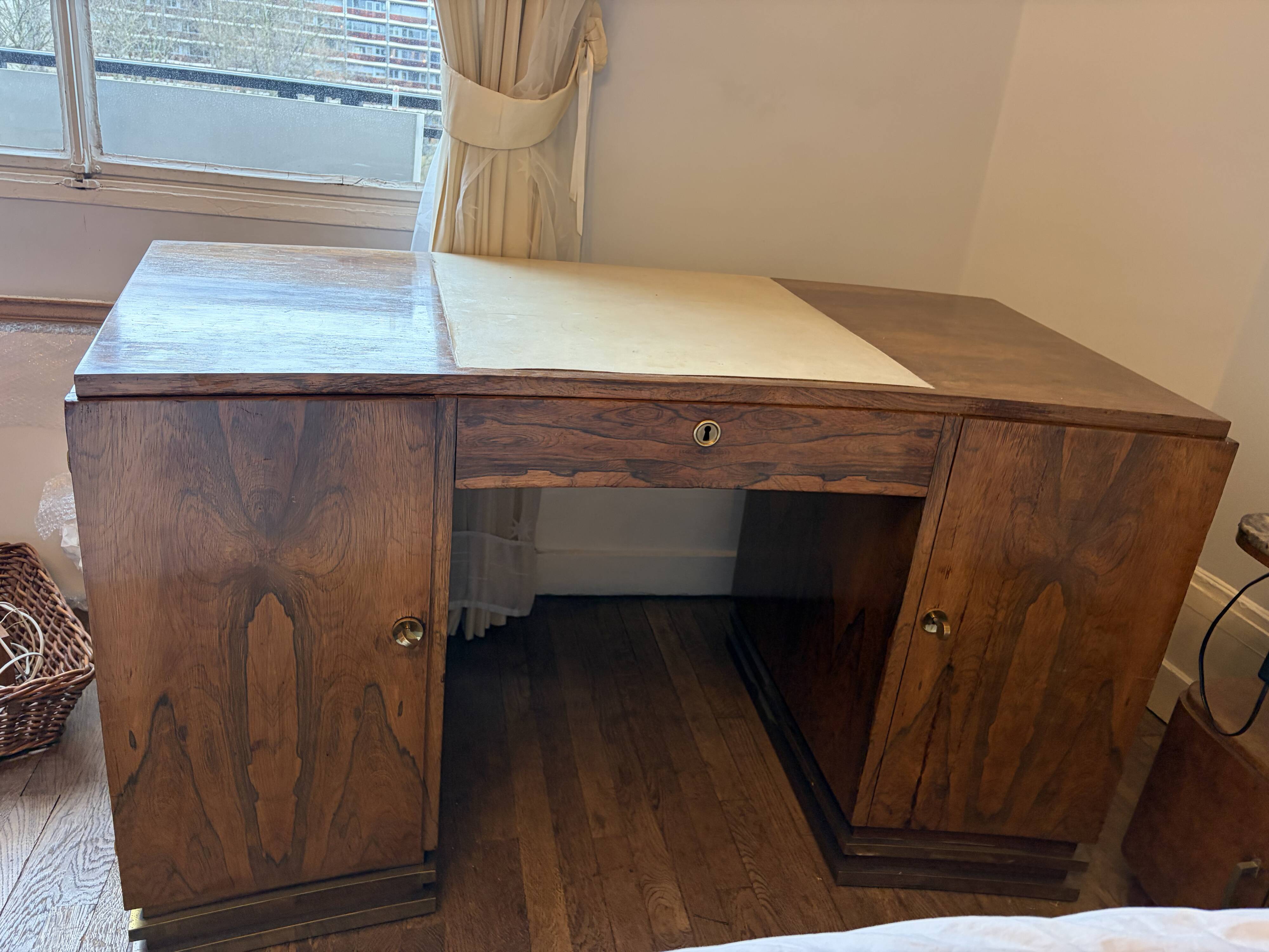 Art Deco desk in a boomerang shape with English-style drawers.