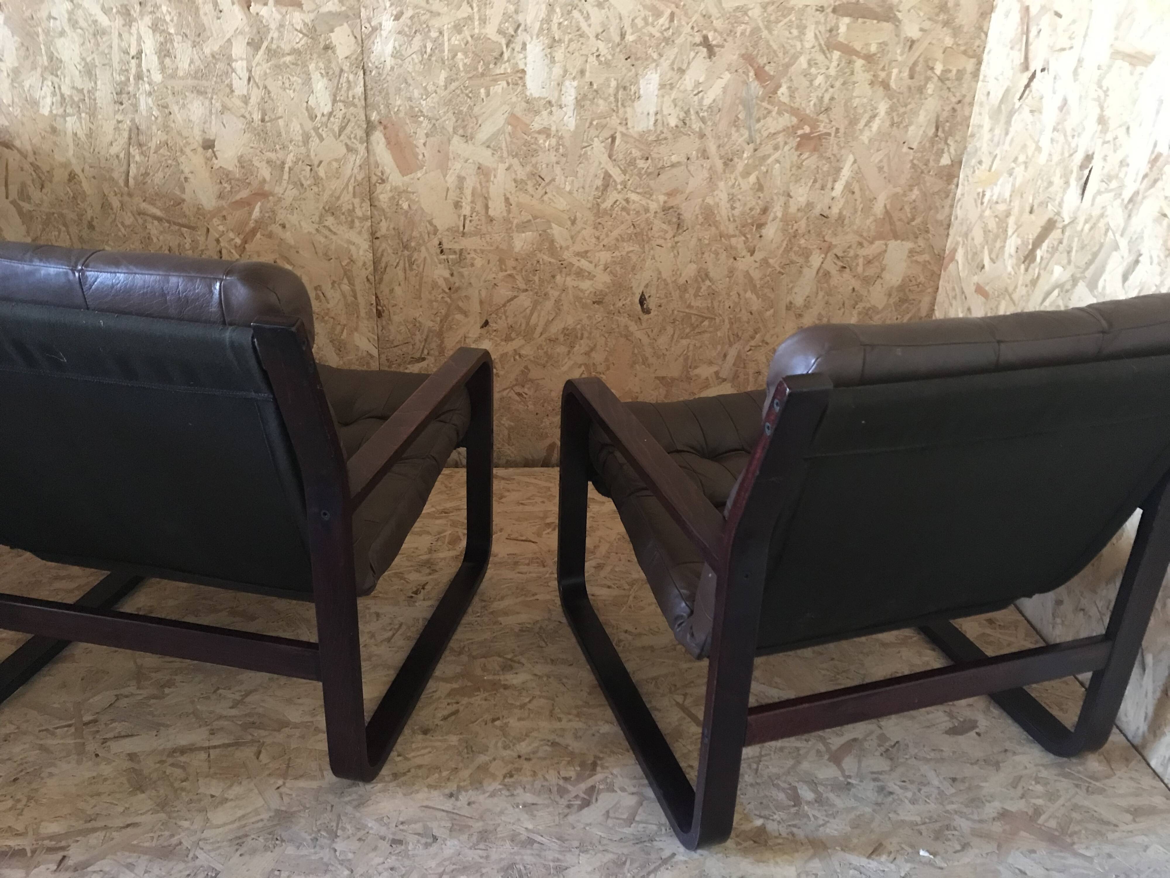 Pair of vintage armchairs in curved wood with suspended seat circa 1970-80.