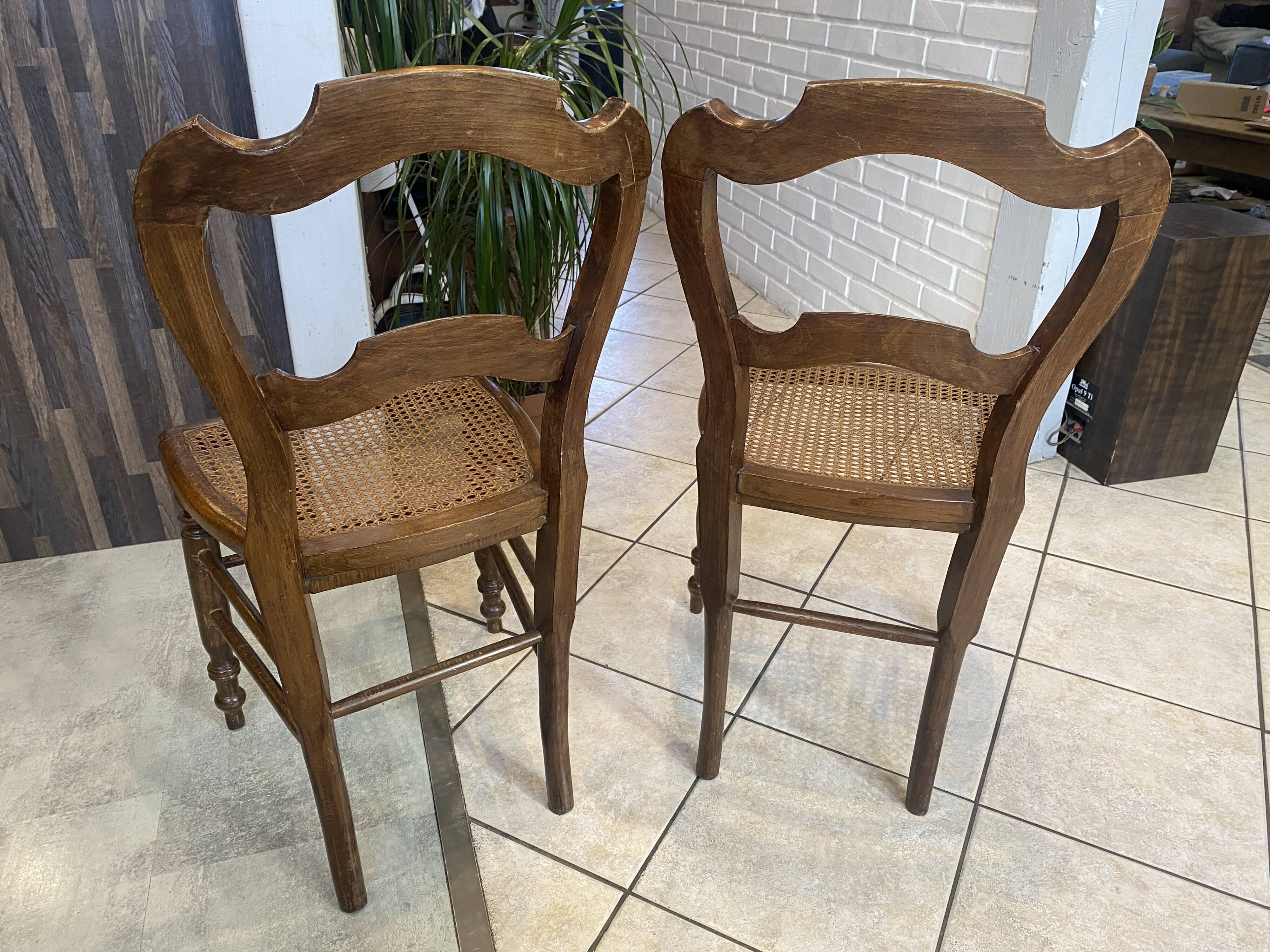 Pair of N2 antique caned and wooden chairs from the 1900s.