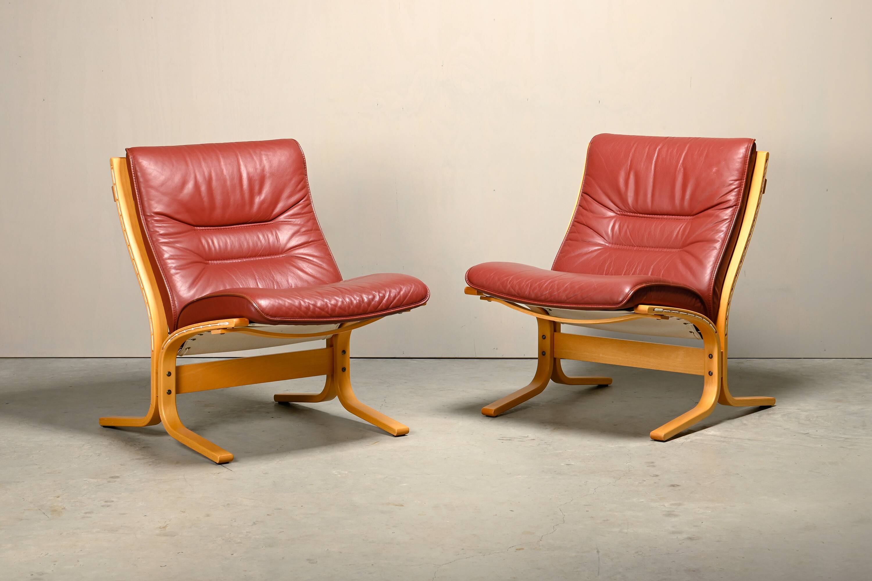 Pair Ingmar Relling Siesta Lounge Chairs in Beech and Burgundy Leather