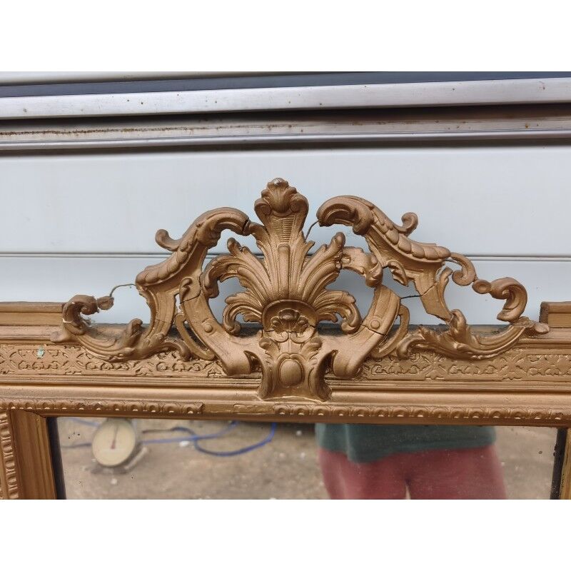 19th-century mirror in gilded wood and stucco.