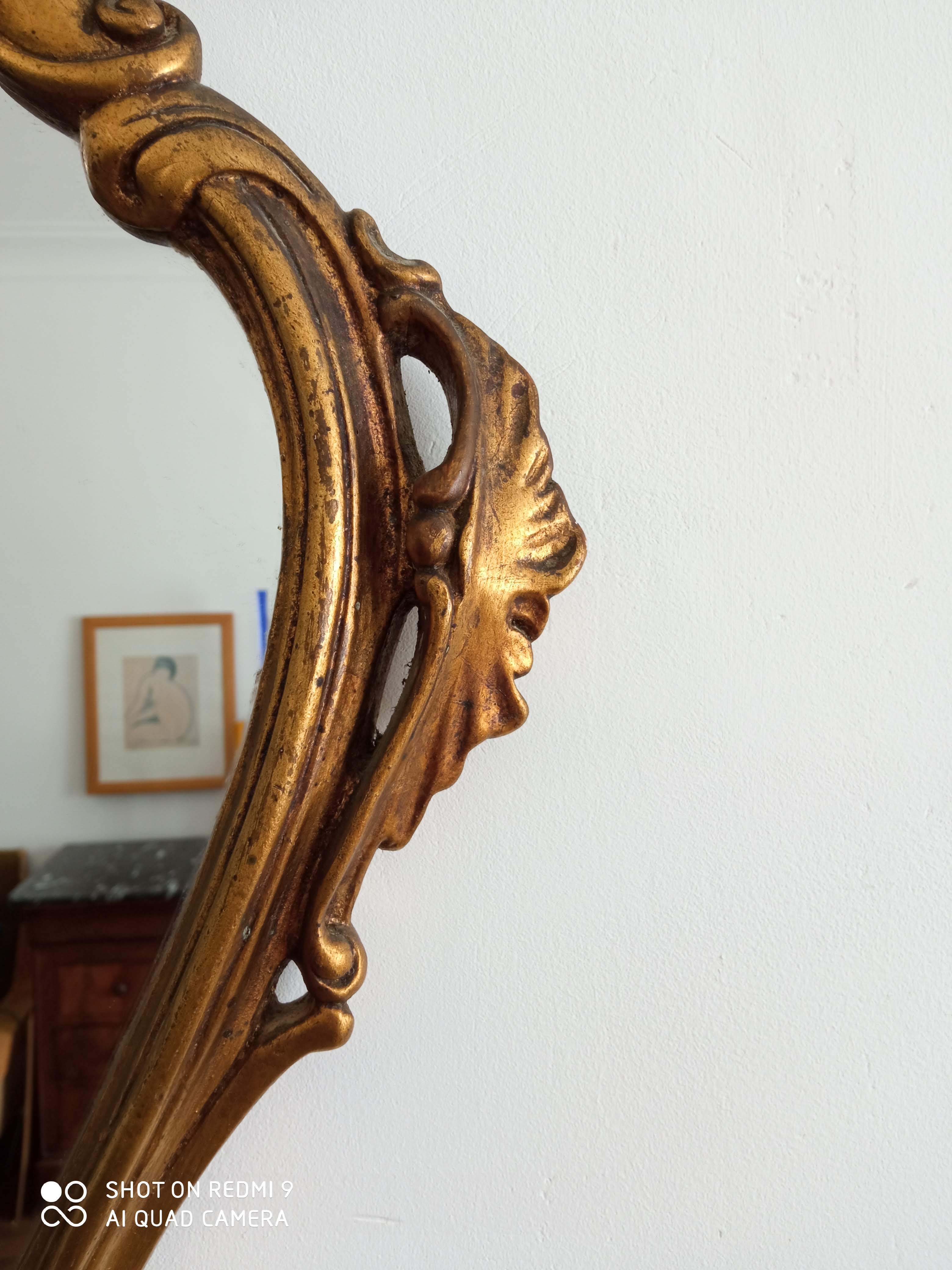 Old wooden mirror and gilded stucco