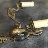 Antique bronze wall light with arm decorated with swans and palmettes in the Empire style