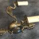 Antique bronze wall light with arm decorated with swans and palmettes in the Empire style