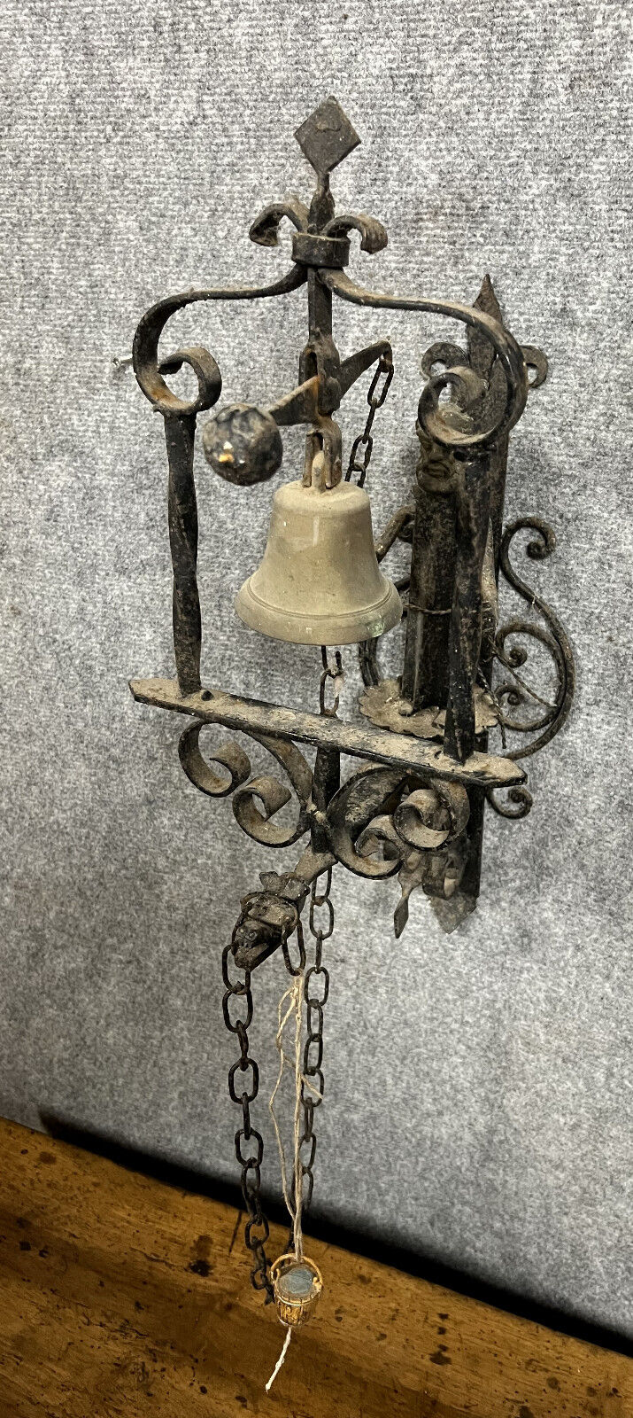 Wrought iron entrance bell depicting a monk ringing a bell circa 1900-1930