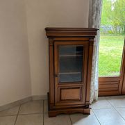 Small glass-fronted accent cabinet in cherry wood.