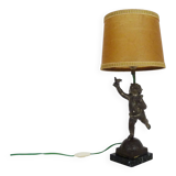 Old table lamp in repel, cherub, angel, cherub, putti with a bird in hand. 1930s
