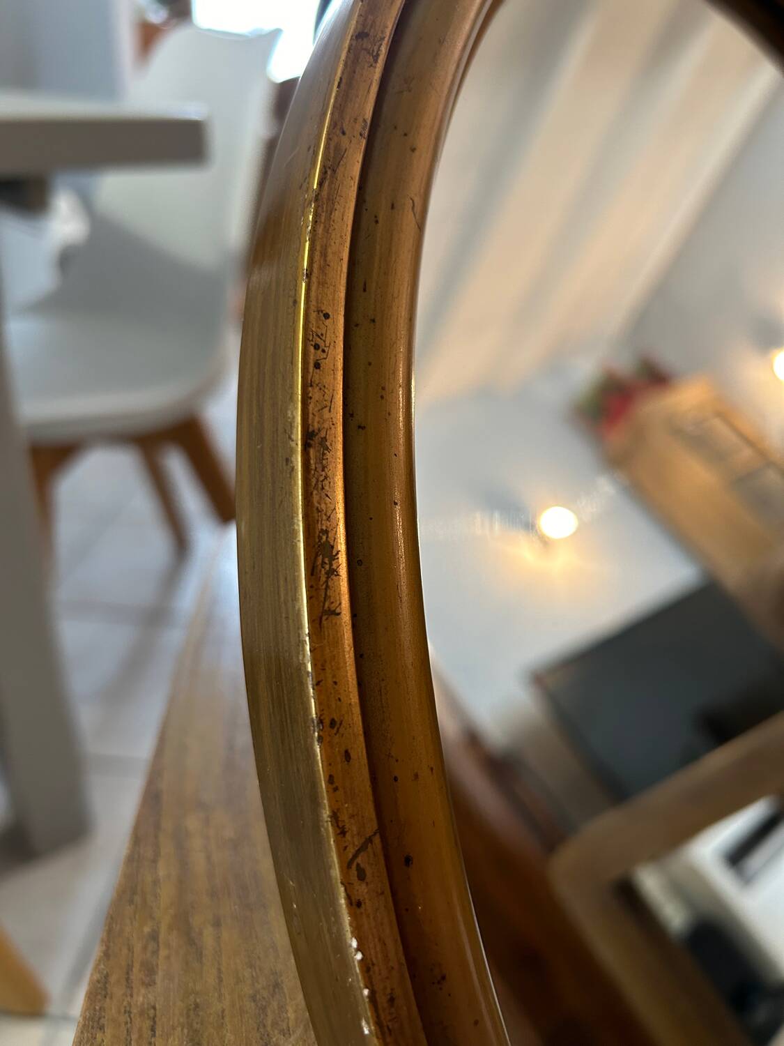 Old oval mirror in gilded wood from the 20th century